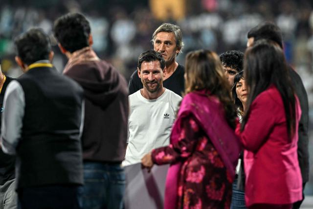 Argentina's footballer Lionel Messi (C) interacts with people during his GOAT Tour at the Wankhede Stadium in Mumbai on December 14, 2025. (Photo by Indranil MUKHERJEE / AFP)