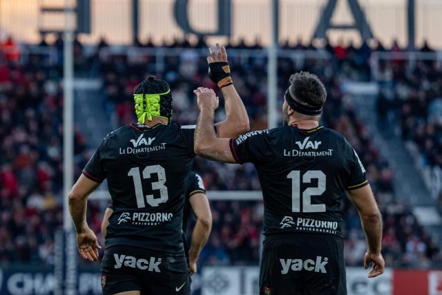 Toulon's Argentine-Italian centre Ignacio Brex (L) is congratulated by Toulon's French center Jeremy Sinzelle  after scoring a try during the European Rugby Champions Cup Pool 2 rugby union match between Toulon (FRA) and Bath (ENG) at the Mayol stadium in Toulon on December 14, 2025. (Photo by MIGUEL MEDINA / AFP)