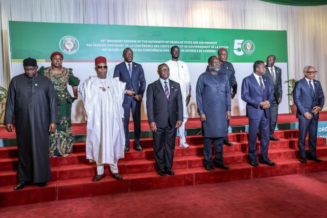 (From L to R) President of The Gambia Adama Barrow, Liberia’s Minister of Foreign Affairs Sara Beysolow Nyanti, Nigeria’s Vice President Kashim Shettima, Benin’s Minister of Foreign Affairs Olushegun Adjadi Bakari, President of Sierra Leone Julius Maada Bio, President of Senegal Bassirou Diomaye Faye, President of the ECOWAS Commission Omar Touray, President of Ghana John Dramani Mahama, Vice President of Ivory Coast Tiemoko Meyliet Kone and President of Cabo Verde Jose Maria Neves pose for a group photo during the 68th Ordinary Session of the Authority of Heads of State and Government of the Economic Community of West African States (ECOWAS) at the Presidential Villa in Abuja on December 14, 2025. Presidents and their deputies from across west Africa met on December 14, 2025 in Nigeria for a regional meeting whose agenda was dominated by two recent coup attempts.
A successful putsch in Guinea Bissau in November and a foiled military takeover in Benin a week ago have rattled regional bloc ECOWAS. (Photo by Light Oriye Tamunotonye / AFP)