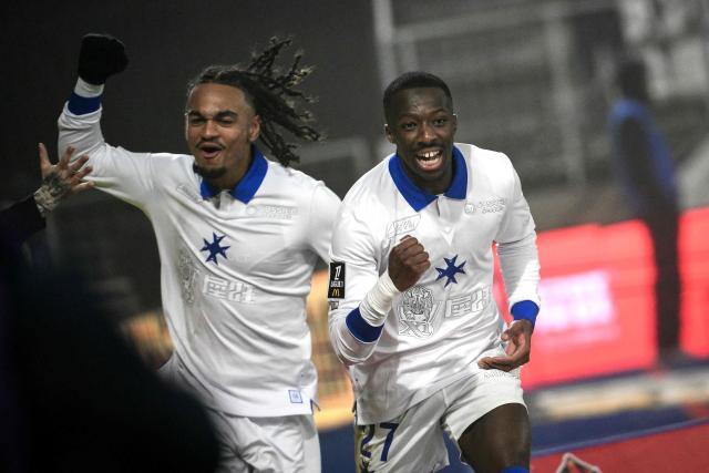 Auxerre’s French defender #27 Lamine Sy (R) and Auxerre’s French forward #09 Sekou Mara celebrate after the team scored a goal during the French L1 football match between AJ Auxerre and Lille LOSC at the Stade de l'Abbe-Deschamps in Auxerre, central France, on December 14, 2025. (Photo by ARNAUD FINISTRE / AFP)