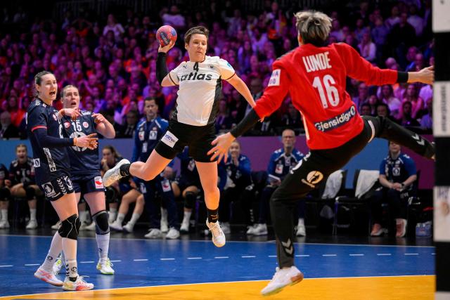 Germany's centre back #04 Alina Grijseels (C) shoots during the IHF Women's Handball World Championship final match between Germany and Norway at the Rotterdam Ahoy Arena, in Rotterdam on December 14, 2025. (Photo by JOHN THYS / AFP)