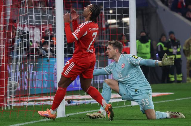 Bayern Munich's German forward #07 Serge Gnabry reacts after failing to score past Mainz' German goalkeeper #33 Daniel Batz during the German first division Bundesliga football match between FC Bayern Munich and Mainz 05 in Munich, southern Germany on December 14, 2025. (Photo by Karl-Josef HILDENBRAND / AFP) / DFL REGULATIONS PROHIBIT ANY USE OF PHOTOGRAPHS AS IMAGE SEQUENCES AND/OR QUASI-VIDEO