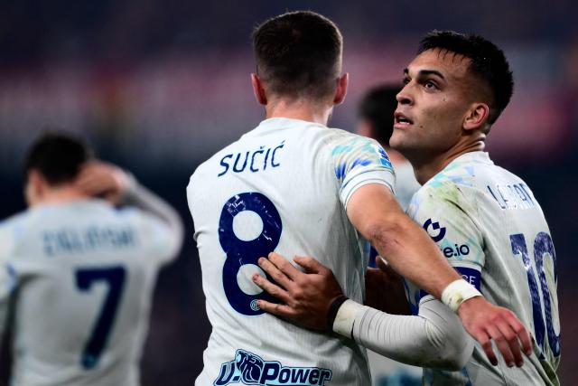 Inter Milan’s Argentine forward #10 Lautaro Martнnez (R) celebrates after scoring a goal with Inter Milan’s Croatian midfielder #8 Petar Sucic during the Italian Serie A football match between Genoa and Inter Milan at Luigi Ferraris Stadium in Genoa on December 14, 2025. (Photo by MARCO BERTORELLO / AFP)