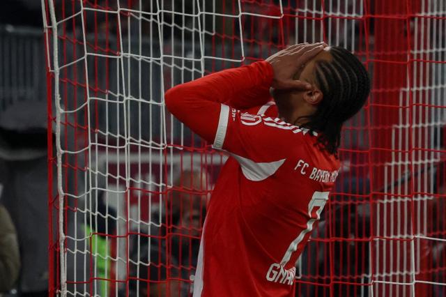 Bayern Munich's German forward #07 Serge Gnabry reacts after failing to score during the German first division Bundesliga football match between FC Bayern Munich and Mainz 05 in Munich, southern Germany on December 14, 2025. (Photo by Karl-Josef HILDENBRAND / AFP) / DFL REGULATIONS PROHIBIT ANY USE OF PHOTOGRAPHS AS IMAGE SEQUENCES AND/OR QUASI-VIDEO
