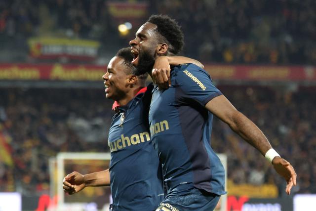Lens' French forward #11 Odsonne Edouard (R) celebrates with Lens' Malian midfielder #08 Mamadou Sangare after scoring his team second goal during the French L1 football match between RC Lens and OGC Nice at the Stade Bollaert-Delelis in Lens, northern France, on December 14, 2025. (Photo by Francois LO PRESTI / AFP)