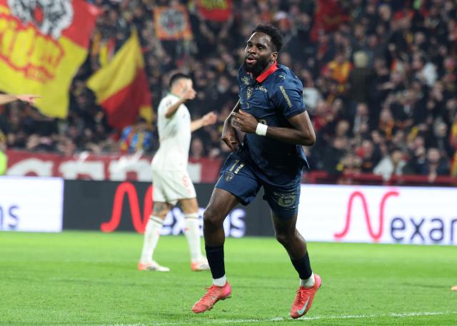 Lens' French forward #11 Odsonne Edouard celebrates after scoring his team second goal during the French L1 football match between RC Lens and OGC Nice at the Stade Bollaert-Delelis in Lens, northern France, on December 14, 2025. (Photo by Francois LO PRESTI / AFP)