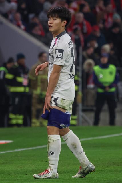 Mainz' Japanese midfielder #24 Sota Kawasaki after receiving medical attention during the German first division Bundesliga football match between FC Bayern Munich and Mainz 05 in Munich, southern Germany on December 14, 2025. (Photo by Karl-Josef HILDENBRAND / AFP) / DFL REGULATIONS PROHIBIT ANY USE OF PHOTOGRAPHS AS IMAGE SEQUENCES AND/OR QUASI-VIDEO