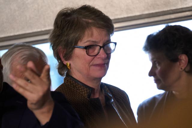 Christina Paxton, the president of Brown University, departs a press conference near the campus of Brown University in Providence, Rhode Island on December 14, 2025. Hundreds of police officers hunted Sunday for a gunman who killed two people and wounded nine others at Brown University, plunging the eastern US campus into lockdown. (Photo by Bing Guan / AFP)