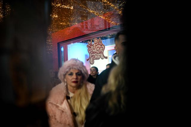 Pedestrians walk past the Galeries Lafayette, days before Christmas, in Paris on December 14, 2025. (Photo by Anna KURTH / AFP)