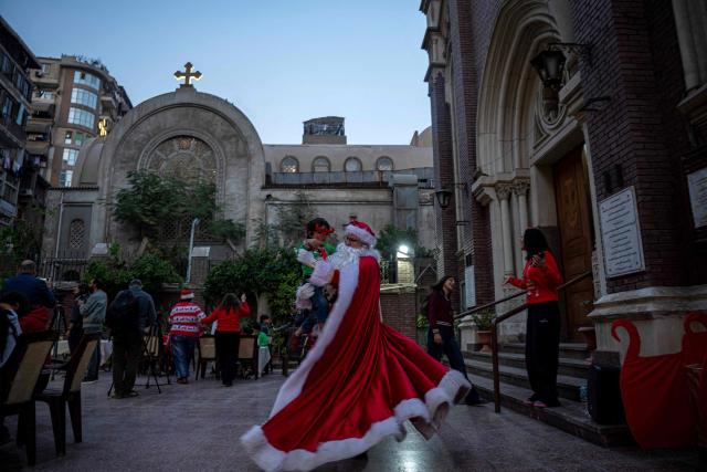 An Egyptian man dressed as Santa Claus at Saint Antoine Latin Catholic Church, during a celebration marking the start of Christmas festivities in downtown the capital Cairo on December 14, 2025. (Photo by Khaled DESOUKI / AFP)