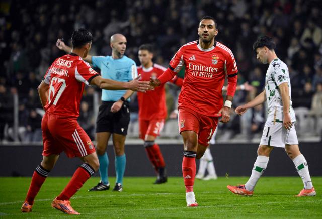 SL Benfica's Greek forward #14 Vangelis Pavlidis celebrates with SL Benfica's Portuguese forward #67 Rodrigo Rego scoring his team's second goal during the Portuguese league football match between Moreirense FC and SL Benfica at the Comendador Joaquim de Almeida Freitas stadium in Moreira de Conegos on December 14, 2025. (Photo by Miguel RIOPA / AFP)