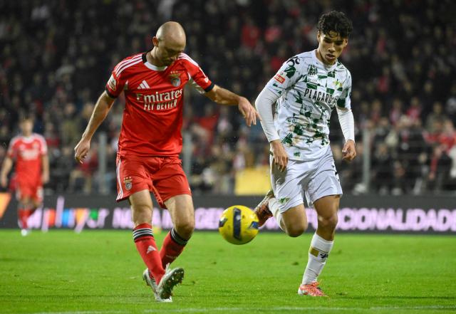 Benfica's Norwegian midfielder #08 Fredrik Aursnes (L) scores his team's fourth goal during the Portuguese league football match between Moreirense FC and SL Benfica at the Comendador Joaquim de Almeida Freitas stadium in Moreira de Conegos on December 14, 2025. (Photo by Miguel RIOPA / AFP)