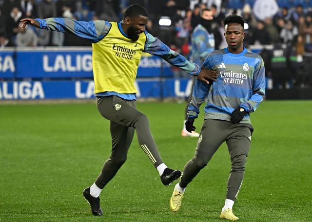 Real Madrid's German defender #22 Antonio Ruediger and Real Madrid's Brazilian forward #07 Vinicius Junior warm up prior the Spanish league football match between Deportivo Alaves and Real Madrid CF at the Mendizorroza stadium in Vitoria on December 14, 2025. (Photo by ANDER GILLENEA / AFP)