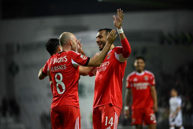 Benfica's Norwegian midfielder #08 Fredrik Aursnes (L) celebrates scoring his team's fourth goal with SL Benfica's Greek forward #14 Vangelis Pavlidis during the Portuguese league football match between Moreirense FC and SL Benfica at the Comendador Joaquim de Almeida Freitas stadium in Moreira de Conegos on December 14, 2025. (Photo by Miguel RIOPA / AFP)