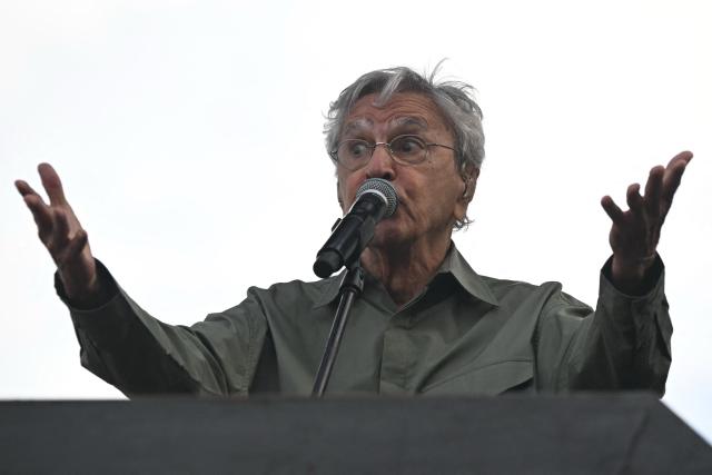 Brazilian artist Caetano Veloso performs during a protest against the Brazilian Congress to reject a bill that would modify penalties for crimes against democracy and thus reduce the sentence of former president Jair Bolsonaro, at Copacabana Beach in Rio de Janeiro, Brazil on December 14, 2025. (Photo by MAURO PIMENTEL / AFP)