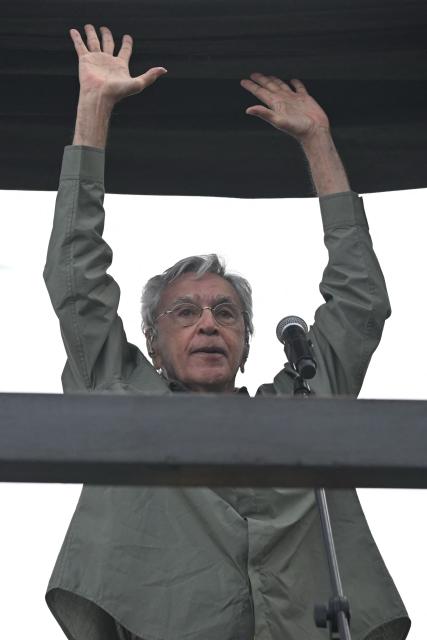 Brazilian artist Caetano Veloso performs during a protest against the Brazilian Congress to reject a bill that would modify penalties for crimes against democracy and thus reduce the sentence of former president Jair Bolsonaro, at Copacabana Beach in Rio de Janeiro, Brazil on December 14, 2025. (Photo by MAURO PIMENTEL / AFP)