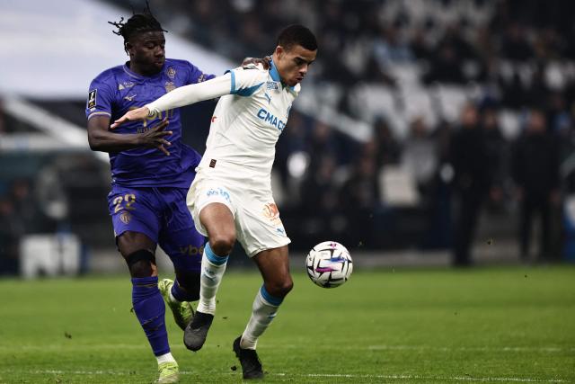 Monaco's Ghanaian defender #22 Mohammed Salisu fights for the ball with Marseille's English forward #10 Mason Greenwood during the French L1 football match between Olympique de Marseille (OM) and AS Monaco at the Stade Velodrome in Marseille, southern France on December 14, 2025. (Photo by Thibaud MORITZ / AFP)