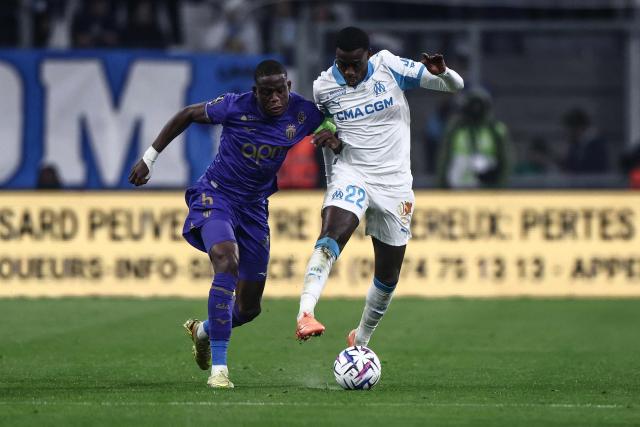 Monaco's Swiss midfielder #06 Denis Zakaria fights for the ball with Marseille's US forward #22 Timothy Weah during the French L1 football match between Olympique de Marseille (OM) and AS Monaco at the Stade Velodrome in Marseille, southern France on December 14, 2025. (Photo by Thibaud MORITZ / AFP)