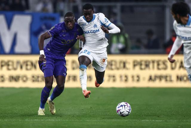 Monaco's Swiss midfielder #06 Denis Zakaria fights for the ball with Marseille's US forward #22 Timothy Weah during the French L1 football match between Olympique de Marseille (OM) and AS Monaco at the Stade Velodrome in Marseille, southern France on December 14, 2025. (Photo by Thibaud MORITZ / AFP)