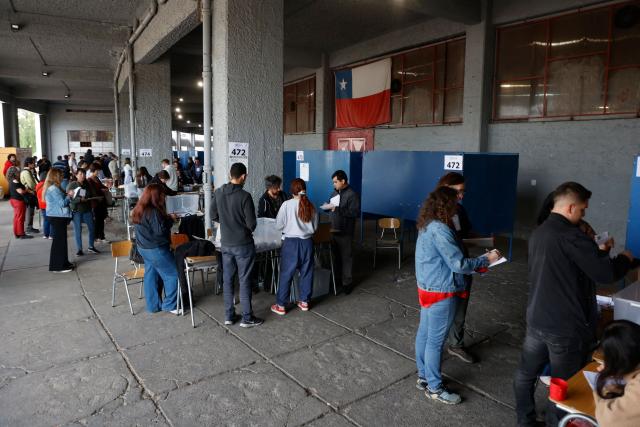 Election officials count votes after polls close during the presidential runoff election in Santiago on December 14, 2025. Chileans head to the polls for a presidential runoff between Jeannette Jara, a communist backed by a broad left coalition, and Jose Antonio Kast, a devout far-right politico promising a hard line on security and migration. (Photo by Raul BRAVO / AFP)