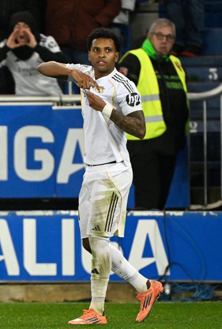 Real Madrid's Brazilian forward #11 Rodrygo celebrates scoring his team's second goal during the Spanish league football match between Deportivo Alaves and Real Madrid CF at the Mendizorroza stadium in Vitoria on December 14, 2025. (Photo by ANDER GILLENEA / AFP)