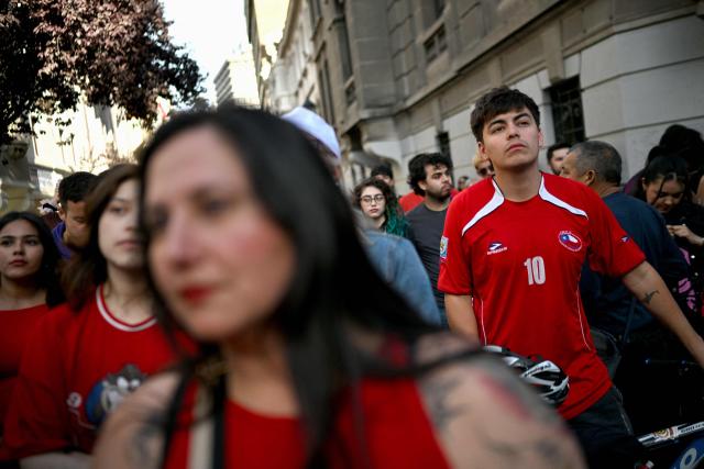 Supporters of Chile's presidential candidate Jeannette Jara, of the Unidad por Chile coalition, react following the first results of the presidential runoff election in Santiago on December 14, 2025. (Photo by Rodrigo ARANGUA / AFP)
