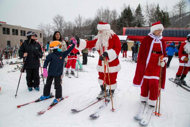 Santa and Mrs. Clause interact with children at South Ridge at Sunday River resort in Newry Maine, on Sunday, December 14, 2025, to raise money for The River Fund and the Boyne Forever Foundation. (Photo by LAUREN OWENS LAMBERT / AFP)