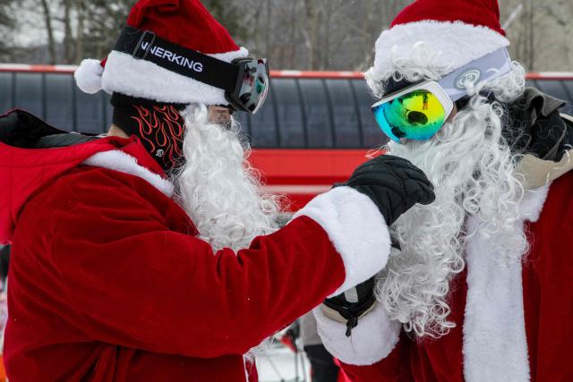 People boot up and get their Santa outfits on at Sunday River resort in Newry Maine, on Sunday, December 14, 2025, to raise money for The River Fund and the Boyne Forever Foundation. (Photo by LAUREN OWENS LAMBERT / AFP)