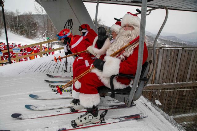 Hundreds of Santas ride up the chairlift at South Ridge at Sunday River resort in Newry Maine, on Sunday, December 14, 2025, to raise money for The River Fund and the Boyne Forever Foundation. (Photo by LAUREN OWENS LAMBERT / AFP)