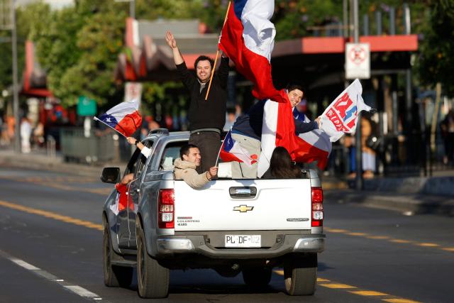 Supporters of Chile's presidential candidate Jose Antonio Kast, of the Partido Republicano party, celebrate following the first results of the presidential runoff election in Santiago on December 14, 2025. Chilean leftist presidential candidate Jeanette Jara conceded defeat to Kast in December 14 election, saying voters had spoken loud and clear. (Photo by Raul BRAVO / AFP)