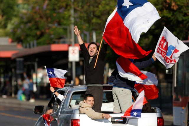 Supporters of Chile's presidential candidate Jose Antonio Kast, of the Partido Republicano party, celebrate following the first results of the presidential runoff election in Santiago on December 14, 2025. Chilean leftist presidential candidate Jeanette Jara conceded defeat to Kast in December 14 election, saying voters had spoken loud and clear. (Photo by Raul BRAVO / AFP)