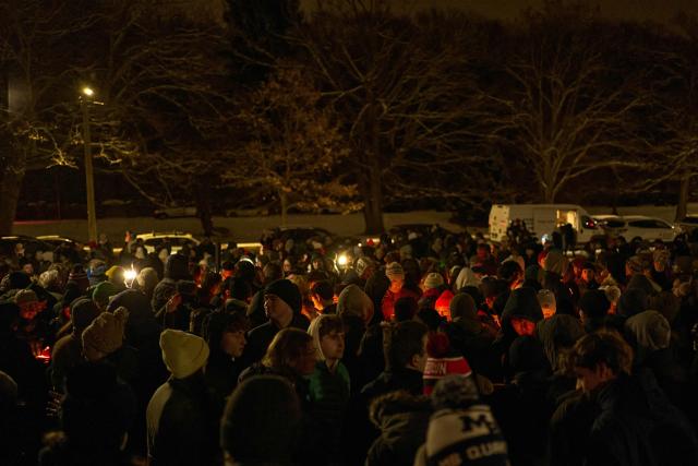 People participate in a candlelight vigil the following day of a mass shooting on the campus of Brown University, in Providence, Rhode Island on December 14, 2025. US authorities on Sunday detained a person of interest in the mass shooting at Brown University that left two people dead and nine others wounded, the latest in a long line of school attacks nationwide. (Photo by Bing Guan / AFP)