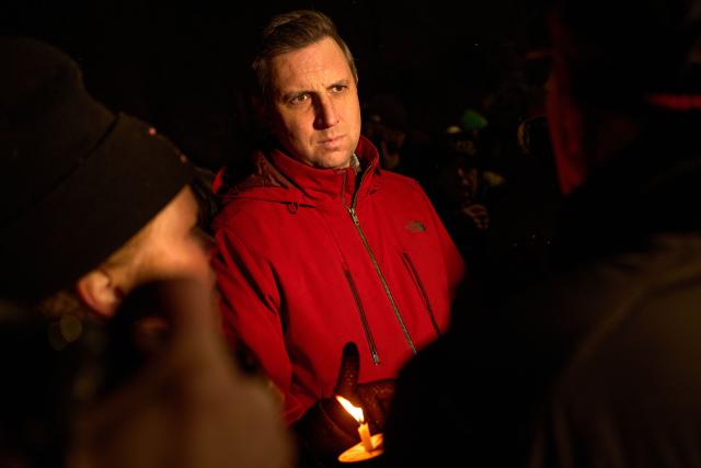 US Representative Seth Magaziner, Democrat of Rhode Island, participates in a candlelight vigil the following day of a mass shooting on the campus of Brown University, in Providence, Rhode Island on December 14, 2025. US authorities on Sunday detained a person of interest in the mass shooting at Brown University that left two people dead and nine others wounded, the latest in a long line of school attacks nationwide. (Photo by Bing Guan / AFP)