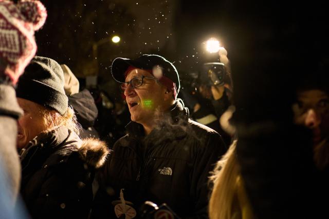 People participate in a candlelight vigil the following day of a mass shooting on the campus of Brown University, in Providence, Rhode Island on December 14, 2025. US authorities on Sunday detained a person of interest in the mass shooting at Brown University that left two people dead and nine others wounded, the latest in a long line of school attacks nationwide. (Photo by Bing Guan / AFP)