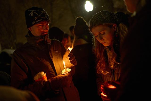 Brown University students participate in a candlelight vigil the following day of a mass shooting on the campus of Brown University, in Providence, Rhode Island on December 14, 2025. US authorities on Sunday detained a person of interest in the mass shooting at Brown University that left two people dead and nine others wounded, the latest in a long line of school attacks nationwide. (Photo by Bing Guan / AFP)