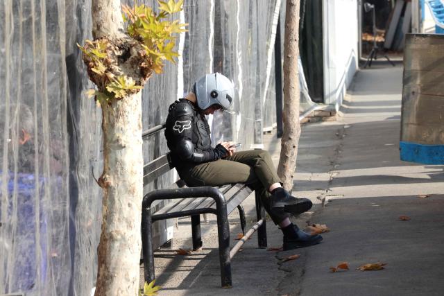 Iranian female student Narghes checks her mobile phone prior to the start of her motorbike riding lesson at a training center, in northern Tehran on December 7, 2025. Despite the progress, motorbike and scooter licensing for women remains a major hurdle in Iran and a legally grey area.
While traffic laws do not explicitly ban women from riding, authorities have never issued motorcycle licences to them in practice, with the issue gaining urgency with the noticeable rise in women riding. (Photo by ATTA KENARE / AFP)