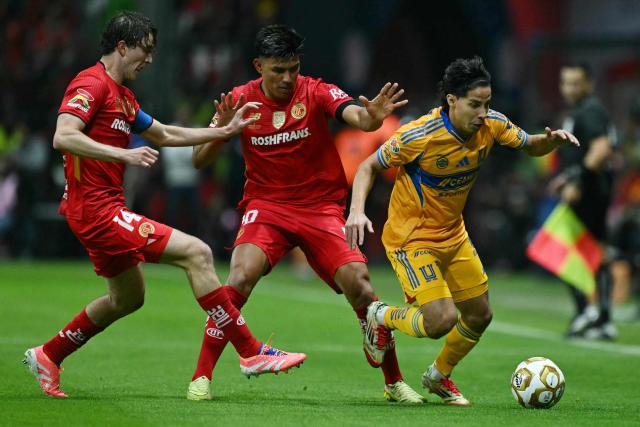 Toluca's midfielder #14 Marcel Ruiz, Toluca's defender #20 Jesus Gallardo and Tigres' midfielder #16 Diego Lainez fight for the ball during the Liga MX Apertura final second leg football match between Toluca and Tigres at the Nemesio Diez stadium in Toluca, Mexico on December 14, 2025. (Photo by Yuri CORTEZ / AFP)