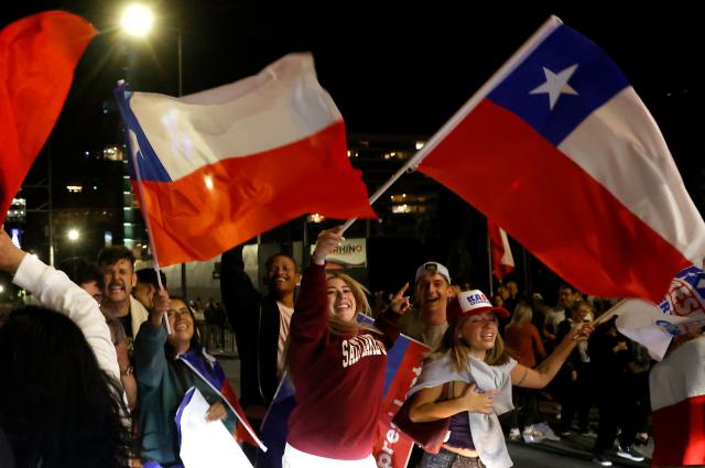 Supporters of Chile's presidential candidate Jose Antonio Kast, of the Partido Republicano party, celebrate the results of the presidential runoff election in Santiago on December 14, 2025. Chilean voters elected Jose Antonio Kast, the most right-wing president in 35 years of democracy, with a thumping 58 percent of votes and his rival Jeannette Jara conceding defeat, according to official results on December 14, 2025. (Photo by Raul BRAVO / AFP)