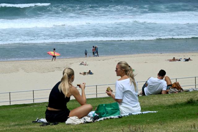 People are seen at Bondi Beach in Sydney on December 15, 2025, a day after the shootings. A father-and-son team toting long-barrelled guns shot and killed 15 people including a 10-year-old girl at Sydney's Bondi Beach on December 14, with authorities labelling it an antisemitic terrorist attack on a Jewish festival. (Photo by Saeed KHAN / AFP)