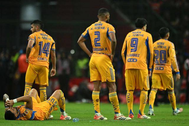 Players of Tigres react after losing the penalty shootout of the Liga MX Apertura final second leg football match between Toluca and Tigres at the Nemesio Diez stadium in Toluca, Mexico on December 14, 2025. (Photo by Yuri CORTEZ / AFP)