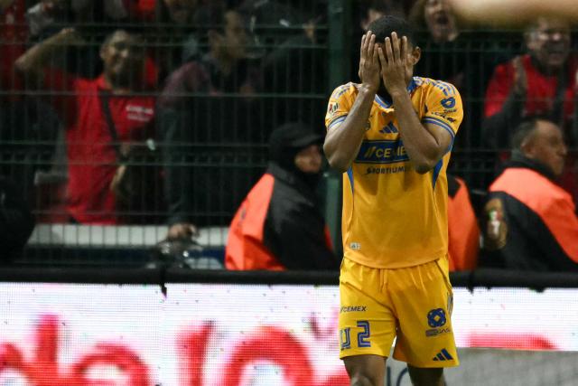 Tigres' Brazilian defender #02 Joaquim Henrique reacts after missing a shot against Toluca's Uruguayan defender #06 Federico Pereira (out of frame) during the penalty shootout of the Liga MX Apertura final second leg football match between Toluca and Tigres at the Nemesio Diez stadium in Toluca, Mexico on December 14, 2025. (Photo by Yuri CORTEZ / AFP)