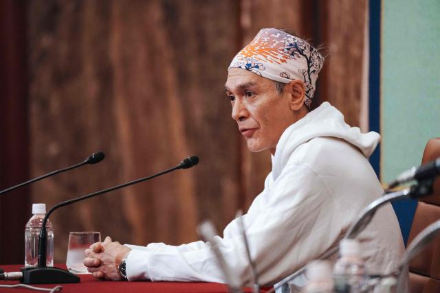 Kim Aris, son of Myanmar's deposed democratic leader Aung San Suu Kyi, speaks during a press conference at the Japan National Press Club in Tokyo on December 15, 2025. (Photo by Kazuhiro NOGI / AFP)