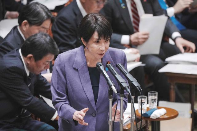 Japan's Prime Minister Sanae Takaichi answers questions during a session of the House of Councillors budget committee in the National Diet in Tokyo on December 15, 2025. (Photo by Kazuhiro NOGI / AFP)