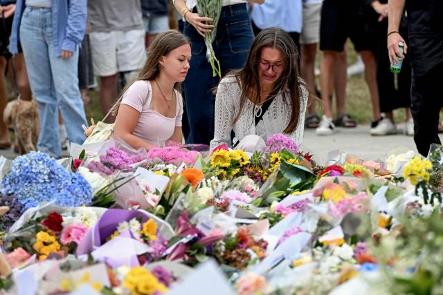 Mourners pay a floral tribute to Bondi Beach shooting victims at the Bondi Pavillion in Sydney on December 15, 2025. A father-and-son team toting long-barrelled guns shot and killed 15 people including a 10-year-old girl at Sydney's Bondi Beach on December 14, with authorities labelling it an antisemitic terrorist attack on a Jewish festival. (Photo by Saeed KHAN / AFP)