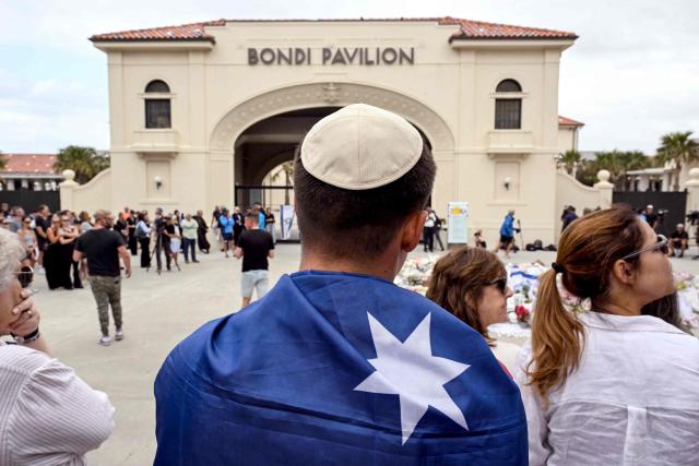 Mourners gather to pay a floral tribute to Bondi Beach shooting victims at the Bondi Pavilion in Sydney on December 15, 2025. A father-and-son team toting long-barrelled guns shot and killed 15 people including a 10-year-old girl at Sydney's Bondi Beach on December 14, with authorities labelling it an antisemitic terrorist attack on a Jewish festival. (Photo by Saeed KHAN / AFP)