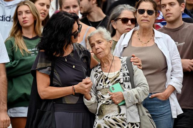 Mourners gather to pay a floral tribute to Bondi Beach shooting victims at the Bondi Pavilion in Sydney on December 15, 2025. A father-and-son team toting long-barrelled guns shot and killed 15 people including a 10-year-old girl at Sydney's Bondi Beach on December 14, with authorities labelling it an antisemitic terrorist attack on a Jewish festival. (Photo by Saeed KHAN / AFP)