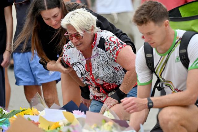 Mourners pay a floral tribute to Bondi Beach shooting victims at the Bondi Pavilion in Sydney on December 15, 2025. A father-and-son team toting long-barrelled guns shot and killed 15 people including a 10-year-old girl at Sydney's Bondi Beach on December 14, with authorities labelling it an antisemitic terrorist attack on a Jewish festival. (Photo by Saeed KHAN / AFP)