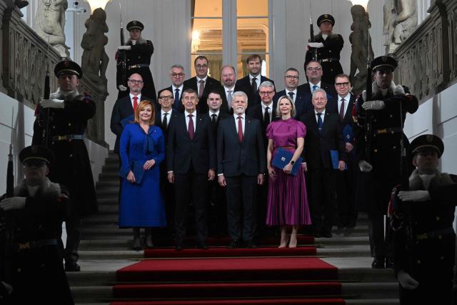 Czech President Petr Pavel (first row, C-R) and Czech Prime Minister Andrej Babis (first row, C-L) pose with newly appointed members of the Czech government for a group photo after Pavel appointed the new cabinet on December 15, 2025 at the Hradcany Castle in Prague, Czech Republic. (Photo by Michal Cizek / AFP)