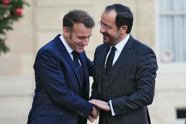 France's President Emmanuel Macron (L) greets Cyprus' President Nikos Christodoulides prior to their meeting at the Elysee Palace in Paris, on December 15, 2025. (Photo by Dimitar DILKOFF / AFP)