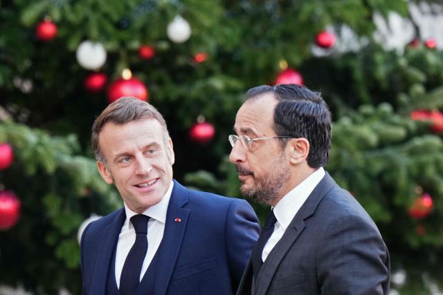 France's President Emmanuel Macron (L) greets Cyprus' President Nikos Christodoulides prior to their meeting at the Elysee Palace in Paris, on December 15, 2025. (Photo by Dimitar DILKOFF / AFP)